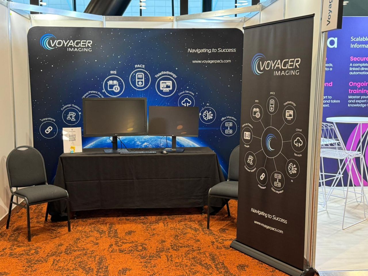 Voyager Imaging RANZCR NZ ASM 2025 booth backdrop showing the full stack: RIS, PACS, TeleRadiology, Clinical and Patient Portals, Customer Support, Integrations, Cloud Services, AI, and Data Migration